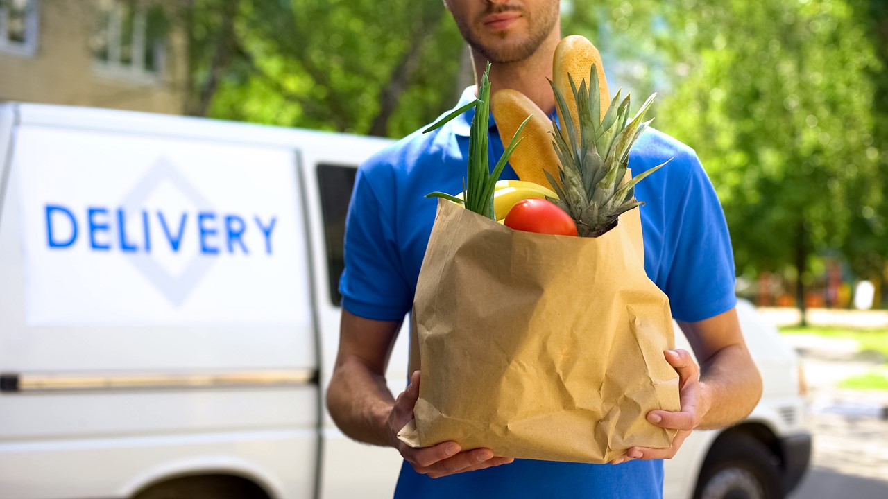 image of a grocery delivery boy in a small commercial van - commercial vehicle insurance louisiana