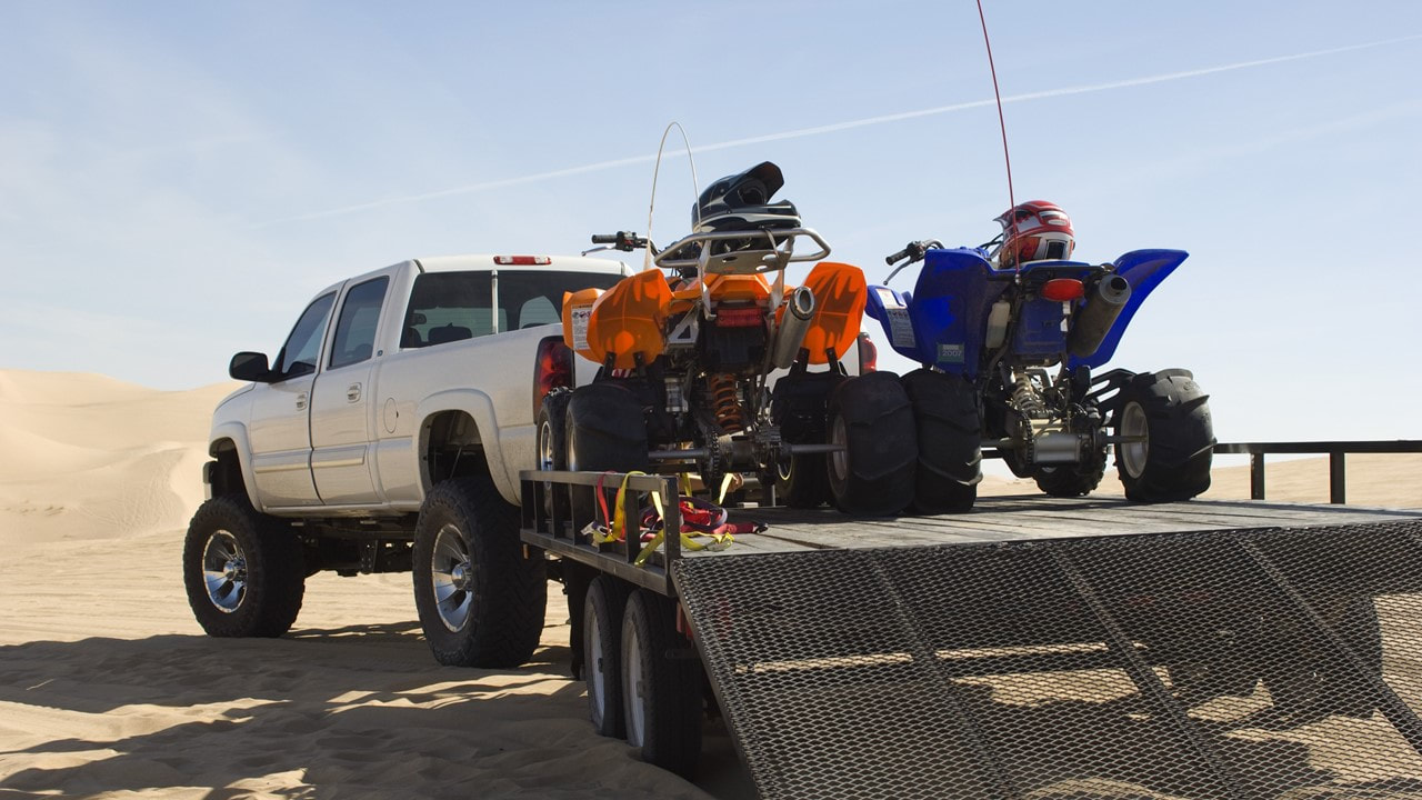 image of a truck pulling a trailer with atv's on it - Trailer Insurance - Lake Charles, LA